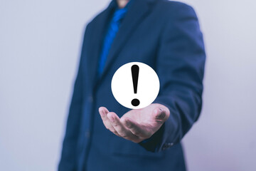 Businessman shows a exclamation mark on hand. warning notification, personal data protection, error...