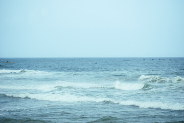 Traditional fishermen rowing a canoe near the rocky shores of Kovalam, Kerala, India. A serene scene capturing coastal life and age-old fishing practices, shot on a Sony Alpha A7 III