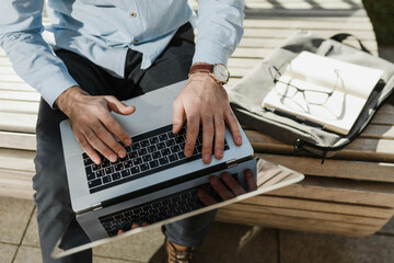 Digital Native Smiling indian businessman working on laptop in modern office