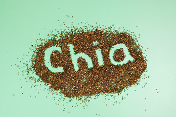 Chia seeds on a green background. The inscription word 