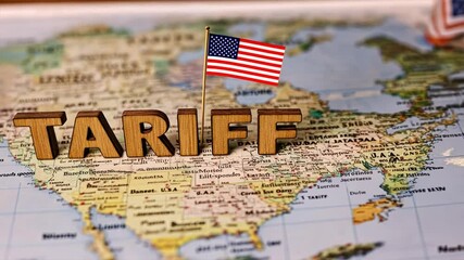 Wooden blocks spelling TARIFF placed on world map show worldwide Import tariffs, Tariffs Tax locations and meaning, Tariff definition in global trade