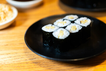 Delicious Sushi Rolls on a Black Plate
