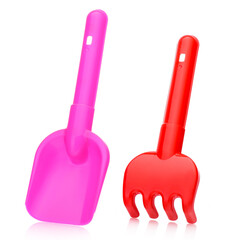 Pink plastic shovel and red rake on a white background for children playing with sand and earth.