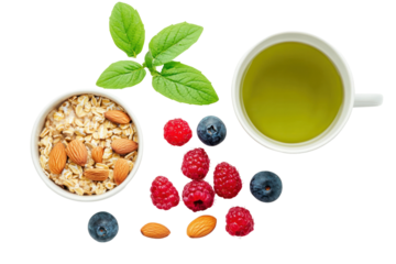 A flat lay of a healthy breakfast spread on a white background, including oatmeal with fresh berries, a cup of green tea, and a few almonds