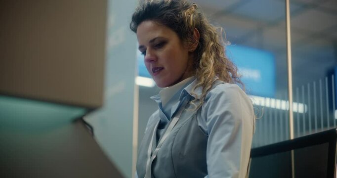 Airport Check-in Counter: Close Up of Female Airline Agent Talking and Checking Boarding Documents of Passenger in International Airport Terminal. Passport Check for Flight at Security Checkpoint.
