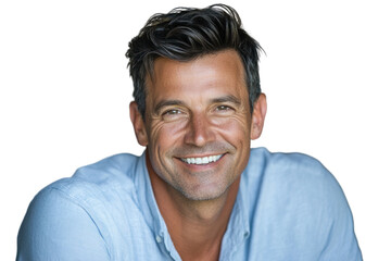 Obraz premium A middle-aged man with short dark hair, smiling confidently at the camera. He is dressed in a light blue shirt, with a slight tilt of his head