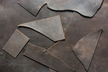 Pieces of genuine cattle leather close-up. Leather goods manufacturing.