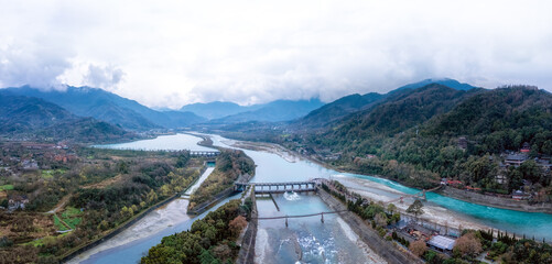 Majestic Aerial View of Serene Rivers and Mountains Under Cloudy Skies