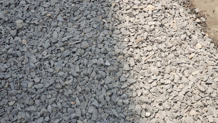 Gray and light gray crushed stone aggregate a construction material photographed outdoors in bright