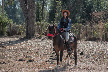 woman riding a horse in farm.	