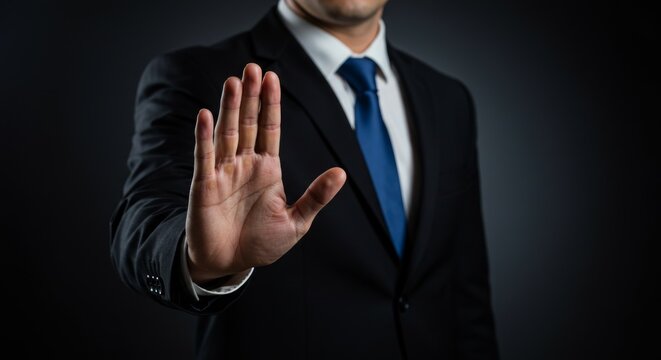 Businessman Holding Out Hand in a Stop Gesture