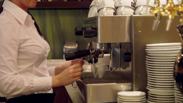 Barista Makes Coffee with a Professional Coffee Machine at a Bar. Barista, Bartender is a Person, Usually a Coffeehouse Employee, who Prepares and Serves Espresso Based Coffee Drinks.