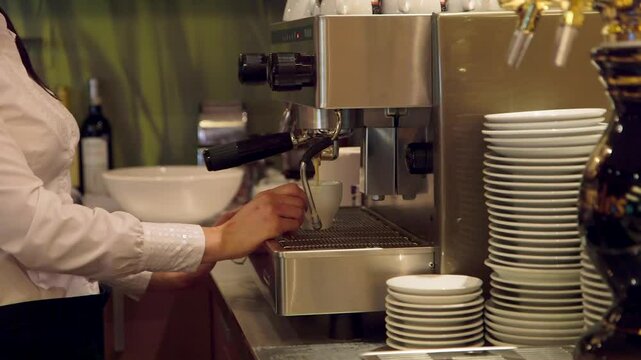 Barista Makes Coffee with a Professional Coffee Machine at a Bar. Barista, Bartender is a Person, Usually a Coffeehouse Employee, who Prepares and Serves Espresso Based Coffee Drinks.