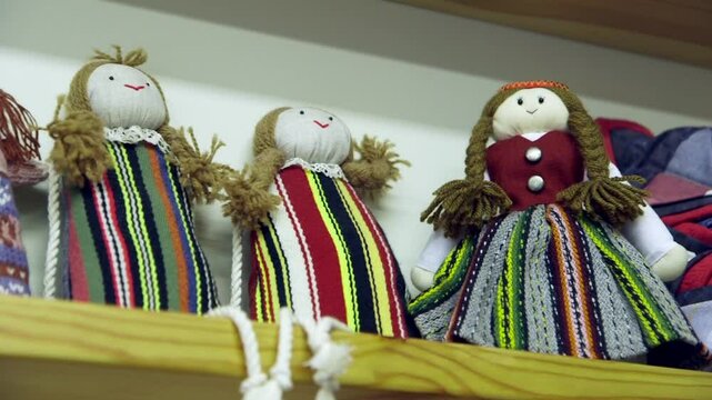 Beautiful Knitted Rag Dolls Arranged on a Shelf in a Children's Room or Shop. A Rag Doll is Made From Scraps of Fabric. One of the Oldest Childrens Toys in Existence.