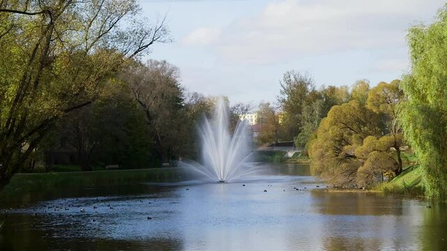 Beautiful, Large Fountain in a City Park Pond or Canal. Lots of Ducks. Autumn. Valmiera is One of the Oldest Cities in Latvia, Having Been a Member of the Hanseatic League.