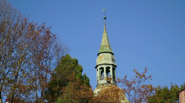 View of an Old Church Tower Surrounded by Autumn Tree Tops. Valmiera is One of the Oldest Cities in Latvia, Having Been a Member of the Hanseatic League.