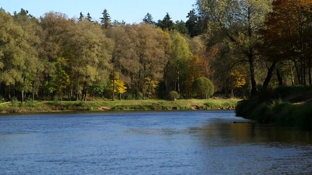 A Small Colorful Tourist Boat - Raft, is Sailing Along the River in Autumn. Valmiera is One of the Oldest Cities in Latvia, Having Been a Member of the Hanseatic League.