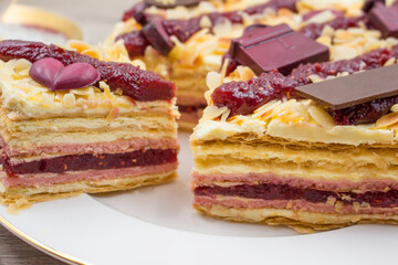 Pieces of cake. Puff pastry, cream and raspberry jam cake slices
