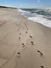Footprints in the Sand on a Deserted Beach on a Sunny Day
