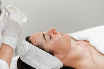 Cosmetology beauty procedures. Lady receiving rejuvenation anti aging treatment, facial chemical...