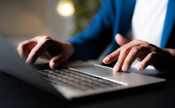 A man using and typing keyboard of laptop computer communicates on internet technology with paperwork on office desk. Workplace, Businessman professional busy working on new job project idea.