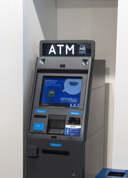 Modern Portuguese ATM machine indoors, featuring a blue touchscreen interface and Multibanco branding. Ideal for concepts related to finance, banking, or secure digital transactions.
