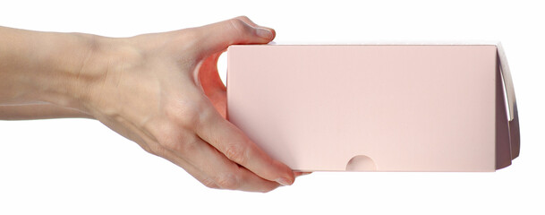 Pink bakery box for cakes or cookies in hand on white background isolation