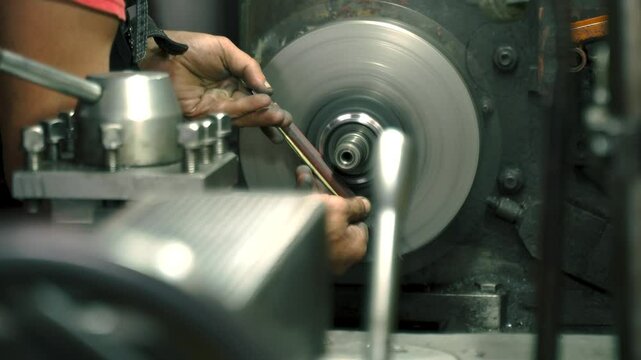 Masterful grinding on a lathe reveals precision engineering in action