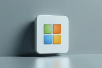 A white square with four colored squares on a gray background surface view