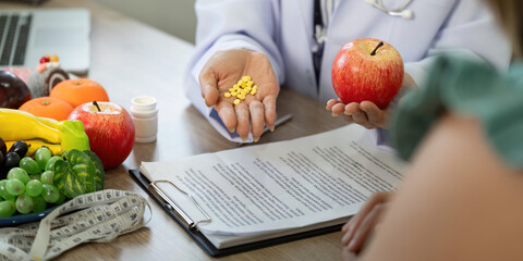 Nutrition and Wellness. A doctor demonstrates the importance of a balanced diet versus supplements.