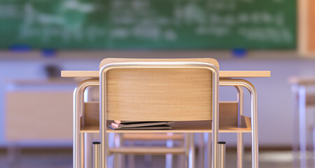School desk and chair with books underneath facing an empty classroom and chalkboard