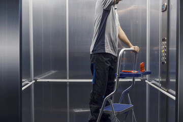 Elevator mechanic repairing the elevator