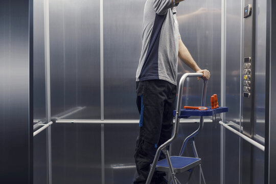 Elevator mechanic repairing the elevator