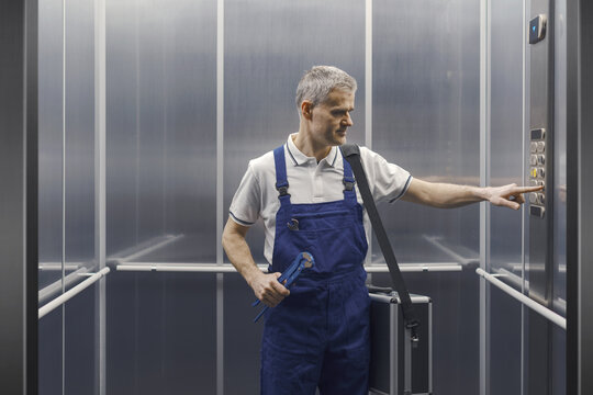 Professional plumber in the elevator - Powered by Adobe