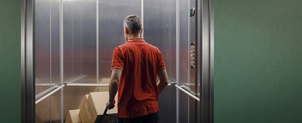 Delivery man getting in the elevator © stokkete