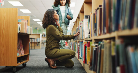 Girl, woman and search by bookshelf at library by shelf with learning, help and education in...