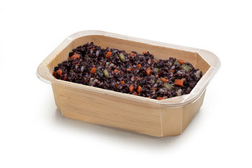 A biodegradable wooden food container filled with a vibrant black rice salad mixed with colorful vegetables like peas, carrots, and peppers. ideal for a healthy meal