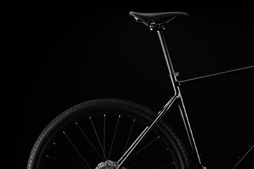 Black Bicycle on Black Background With Detailed Saddle and Rear Wheel
