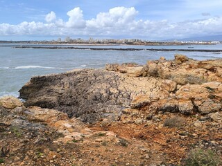 An overcast morning graces the rocky seashore, creating a peaceful and serene atmosphere.