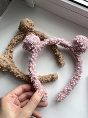 handmade headbands curly texture pink and brown color in girl's hand