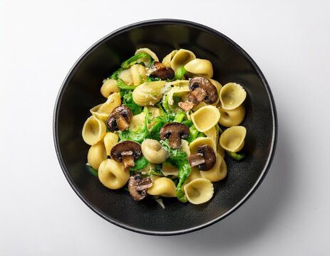 orecchiette pasta dish with cime di rapa mushrooms and spices in black bowl on white background