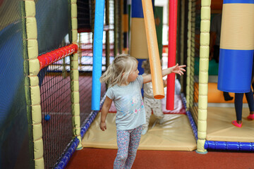 A little girl plays in a children's playground.
