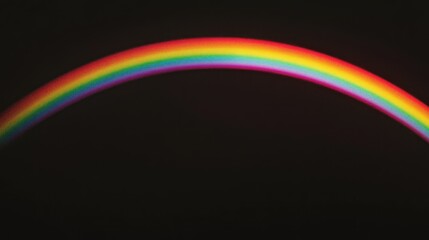 A colorful spectrum arching gracefully across a dark background