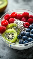 Brightly colored fruit bowl with chia seeds and creamy yogurt served for breakfast in a modern kitchen