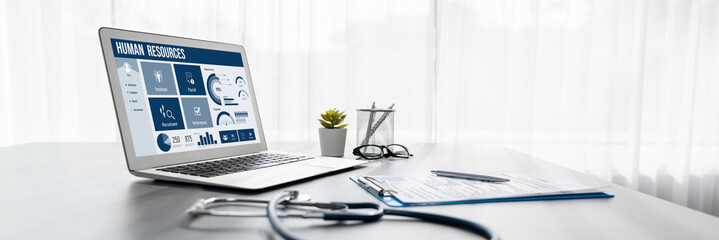 Human resources management software on computer screen helping human resources employee to manage...