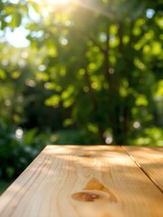 Wooden table top on blur background of green garden with bokeh sunlight. 

