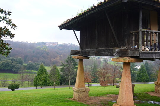 Traditional elevated granary overlooking lush green valley in oviedo, spain
