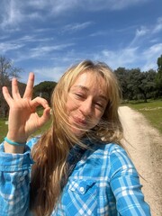 young woman showing thumbs up