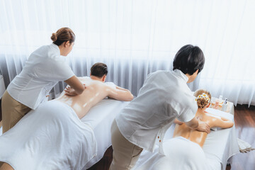 Caucasian couple customer enjoying relaxing anti-stress spa massage and pampering with beauty skin...