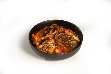 Tasty Funchoza served in a black plate on white background, stock